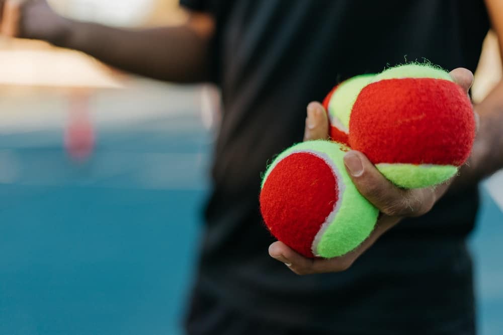 Why do tennis players use extra ball in pockets?