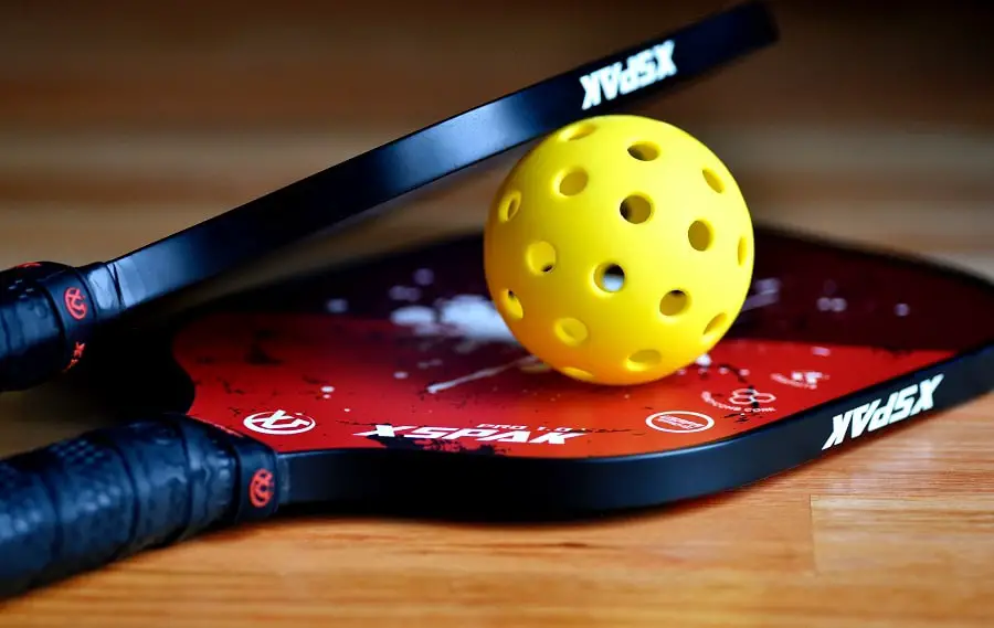 A pickleball paddle and ball is very different from a tennis racket and ball.
